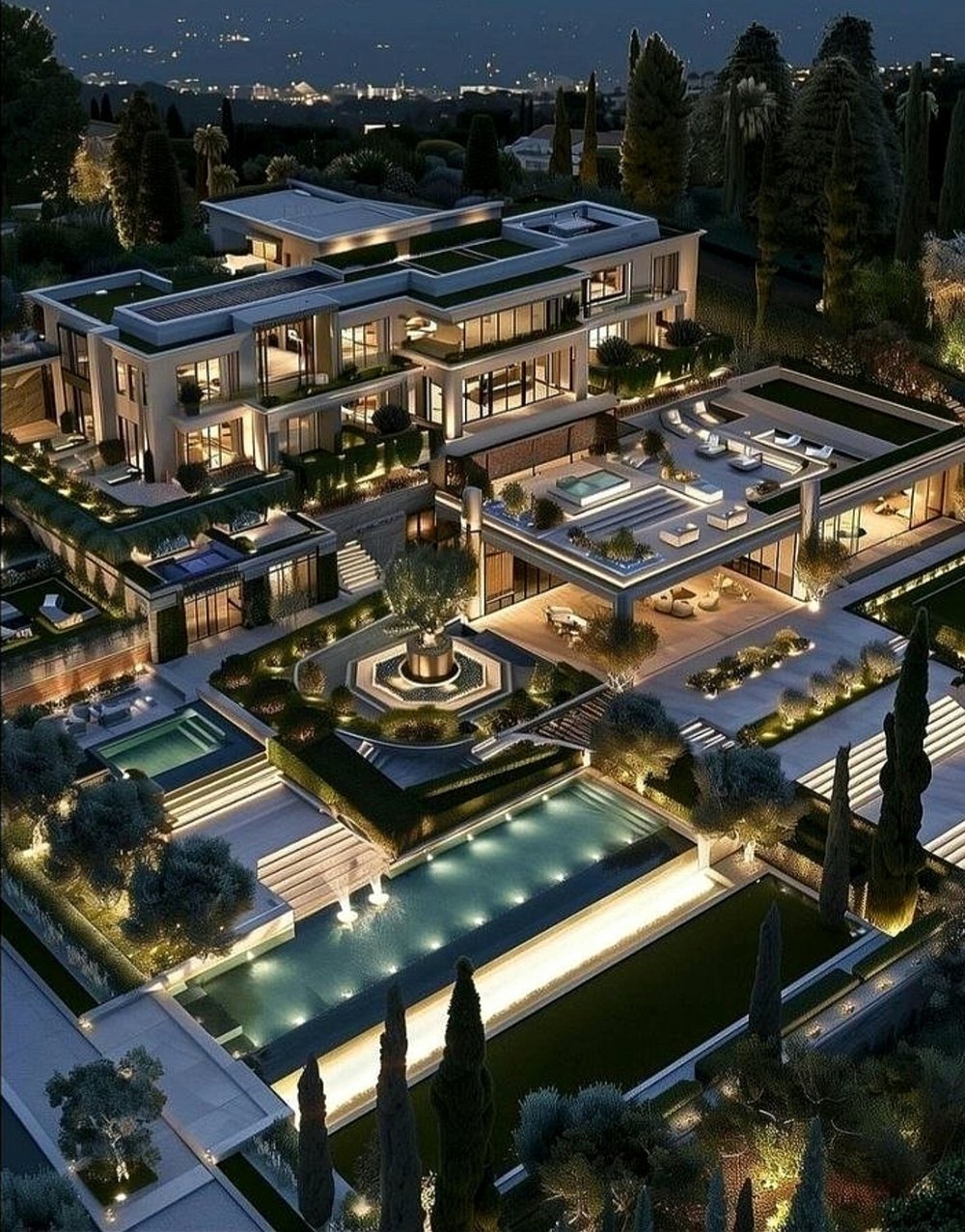 Aerial night view of the estate's terraced gardens, reflecting pools and courtyard fountain